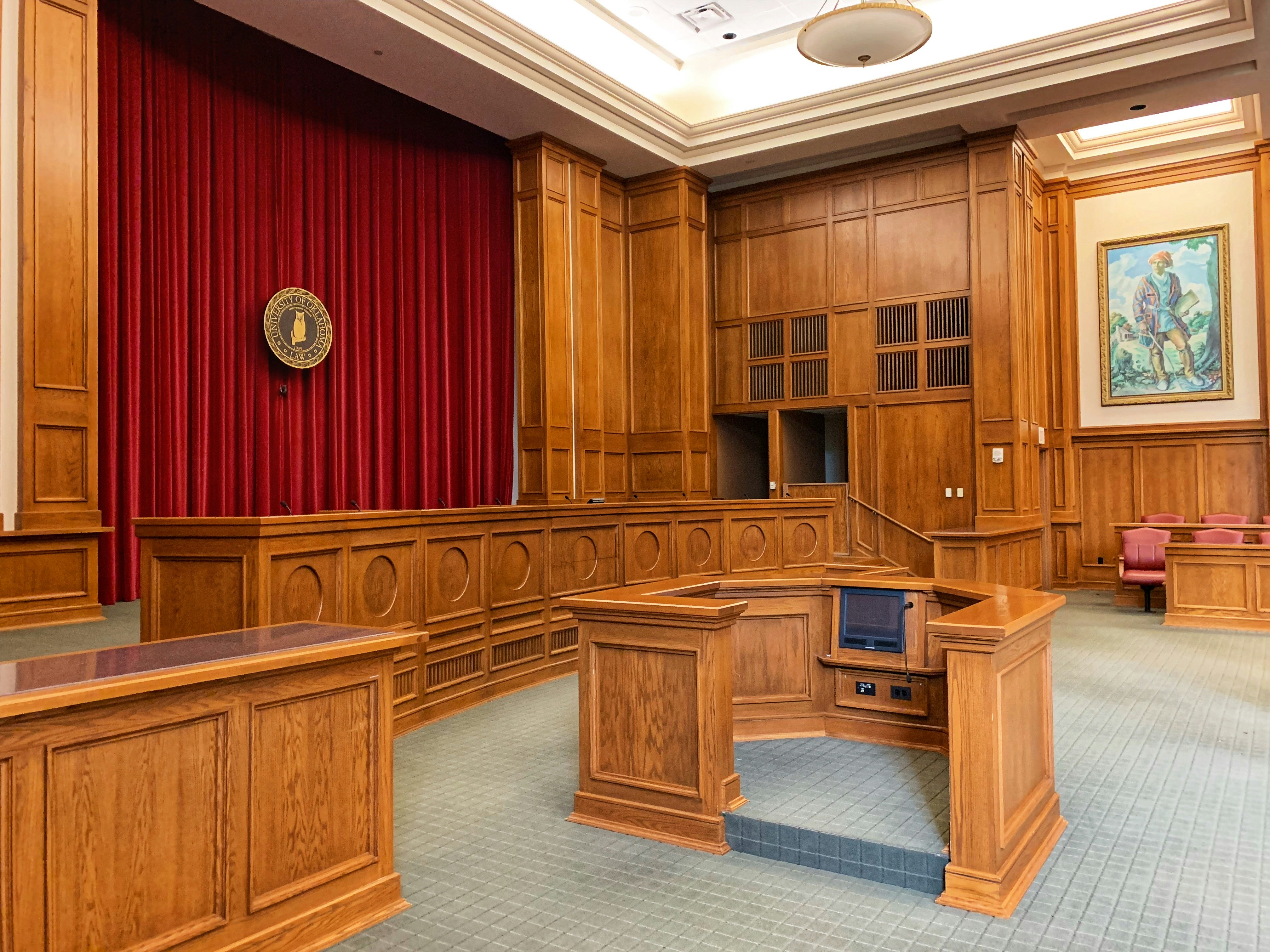 Empty courtroom with judge's bench — bilingual legal staffing by FinesseHire